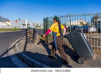 Cape Town, South Africa - October 2020: Black African Female Garbage Collector In Africa During Covid 19 Pandemic Wearing Face Mask For Protection. Front Line Worker, Corona Virus.