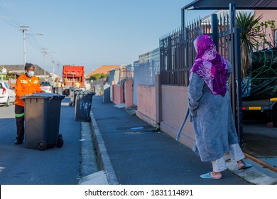 Cape Town, South Africa - October 2020: Black African Garbage Collector In African Muslim Community, During Covid 19 Pandemic Wearing Face Mask For Protection. Front Line Worker, Corona Virus.