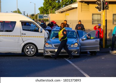 Cape Town, South Africa - October 2020: Black African Woman Fire Fighter At Vehicle Accident Scene Wearing Face Mask For Corona Virus Pandemic In Africa. South African Taxi Accident.