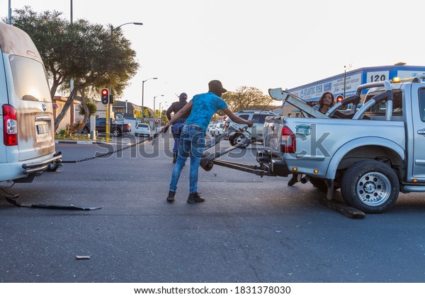 Cape Town, South Africa\
- October 2020: South African Tow Truck driver taking vehicle/taxi\
away from accident scene. Tow Truck hooking car up to pick up truck\
after crash.