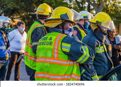 Cape Town, South Africa - September 2020: Black African Female Fire Fighter, Fire And Rescue Saving Victim At Accident Scene