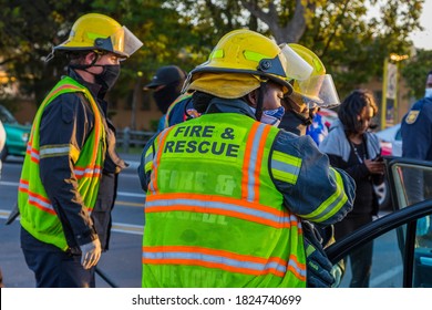 Cape Town, South Africa - September 2020: Black African Female Fire Fighter, Fire And Rescue Saving Victim At Accident Scene