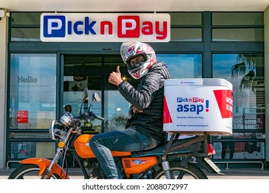 Cape Town, South Africa - September 9, 2021: Express Service Delivery Bikes With African Rider Outside Local Pick N Pay Grocery Store