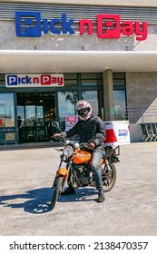 Cape Town, South Africa - September 9, 2021: Express Service Delivery Bikes With African Rider Outside Local Pick N Pay Grocery Store