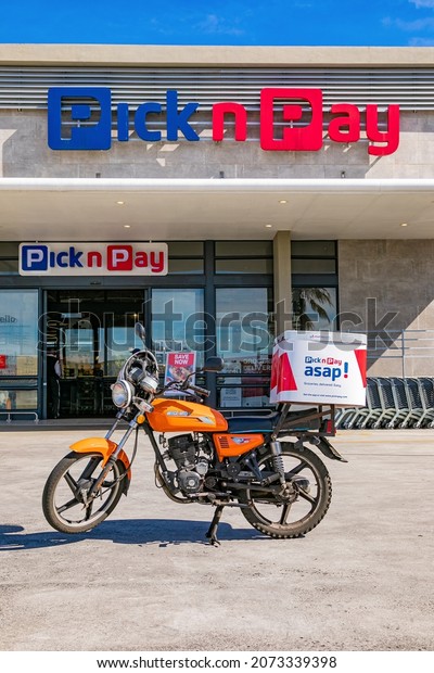 Cape\
Town, South Africa - September 9, 2021: Express Service delivery\
bike parked outside local Pick n Pay grocery\
store