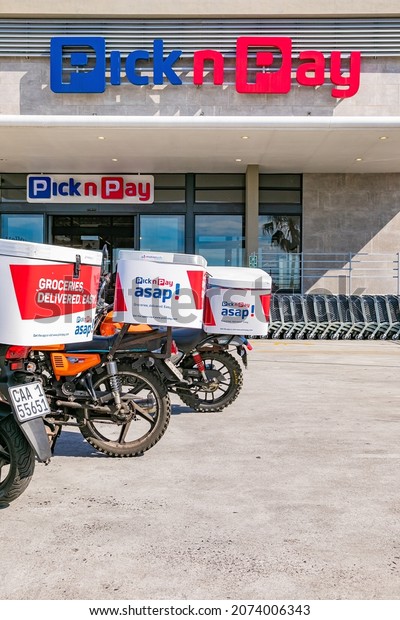 Cape\
Town, South Africa - September 9, 2021: Express Service delivery\
bikes parked outside local Pick n Pay grocery\
store