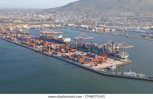 Cape Town, Western Cape / South Africa -\
11/26/2019: Aerial photo of Table Bay Harbour Container Terminal\
with Table Mountain in the\
background