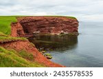 Cape Tryon. Sandstone cliffs along the Gulf of Saint Lawrence, Atlantic Ocean. Coastal erosion, Prince Edward Island north shore, Canada.