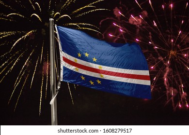 Cape Verde Flag Blowing In The Wind At Night With Fireworks