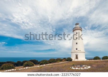 Cape Willoughby active lighthouse viewed against blue sky with clouds on a bright day, Kangaroo Island, South Australia