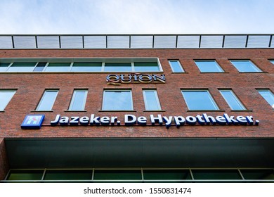 Capelle Aan De IJssel, Netherlands, 11-05-2019.

The Sign Of Quton And The Hupotheker On The Head Quarters In The Netherlands. A Brown Building Whit Big Windows And A Blue Sky. 