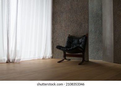 CAPETOWN, SOUTH AFRICA - Nov 22, 2021: A single armchair near white curtains in an apartment in Capetown, South Africa