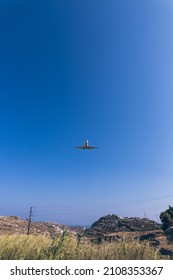 CAPETOWN, SOUTH AFRICA - Nov 22, 2021: A low angle shot of a plane in the clear skies in Capetown, South Africa