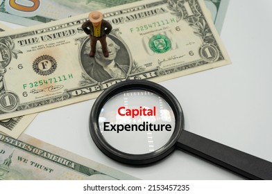 Capital Expenditure.Magnifying Glass Showing The Words.Background Of Banknotes And Coins.basic Concepts Of Finance.Business Theme.Financial Terms.