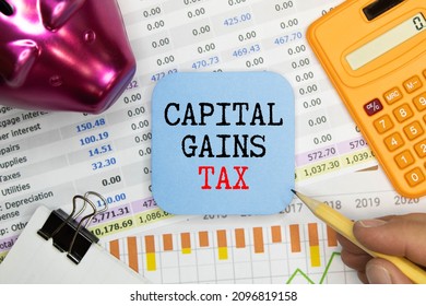 Capital gains tax-text label in the form of a document Registrar planning folder. Mandatory gratuitous payment is established by law by the state government. - Shutterstock ID 2096819158