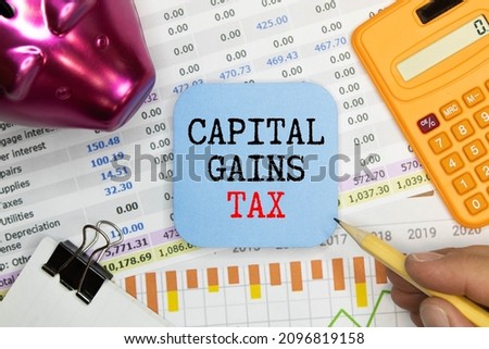 Capital gains tax-text label in the form of a document Registrar planning folder. Mandatory gratuitous payment is established by law by the state government.