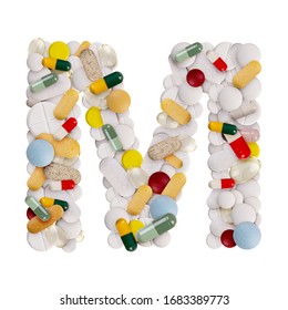 Capital letter M made of various colorful pills, capsules and tablets on isolated white background