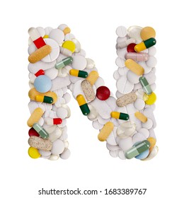 Capital letter N made of various colorful pills, capsules and tablets on isolated white background