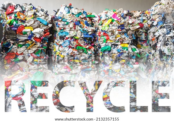 capital letters recycle on plastic pressed bales\
at  modern waste processing plant. Separate garbage collection.\
Recycling and storage of waste for further disposal. Business for\
sorting waste.