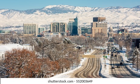 Capital street in Boise Idaho with snow in the foothills and on the road