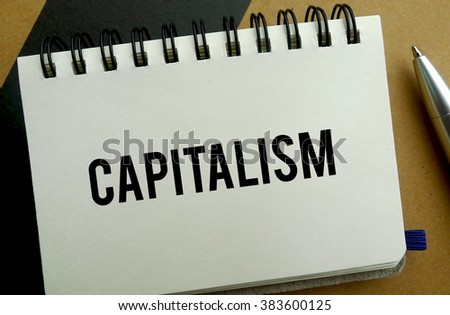 Capitalism memo written on a notebook with pen