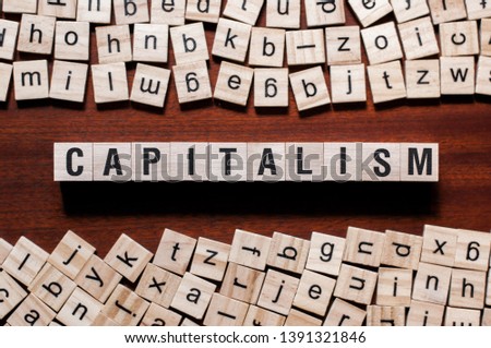 Capitalism word concept on cubes