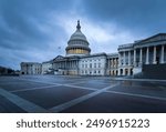 Capitol building in Washington DC illuminated against a stormy sky