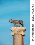 The Capitoline Wolf: Statue of the she-wolf suckling Romulus (founder of Rome) and Remus on column near Capitoline Museums on blue sky background