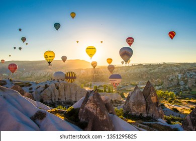 Cappadocia, Turkey - July 05, 2018 : Hot Air Balloons are taking off during sunrise in Cappadocia Region of Turkey.