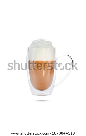  cappuccino with cinnamon on a foam in a transparent cup with a double bottom. isolate on white background