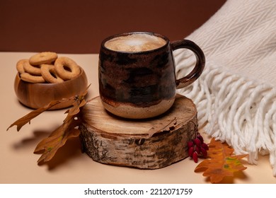 Cappuccino Coffee In A Ceramic Cup, Top View. Milk Foam, Texture. Cappuccino On An Autumn Background With Foliage On A Beige Background.