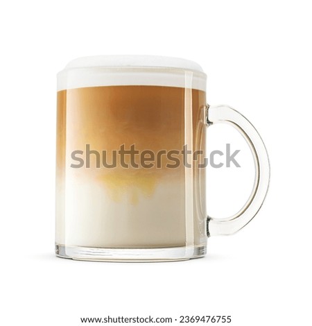 Cappuccino coffee with whipped milk cap in big transparent glass mug isolated on white background.