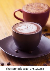 Cappuccino And Creme Brulee Coffee Latte With Coffee Beans On Wooden Background