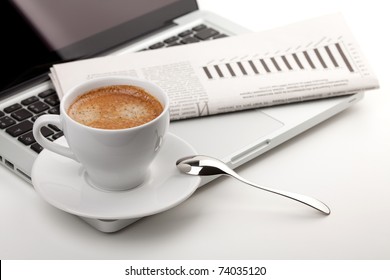 Cappuccino cup with laptop and newspaper - Powered by Shutterstock