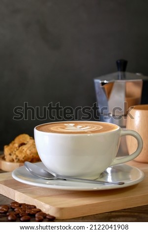 Cappuccino cup,cappuccino coffee in a beautiful glass on the table favorite cup of coffee concept.