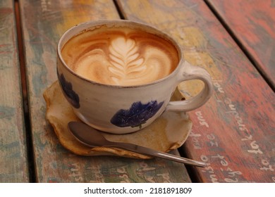 Cappuccino Decoration In A Ceramic Mug With Blue Decor