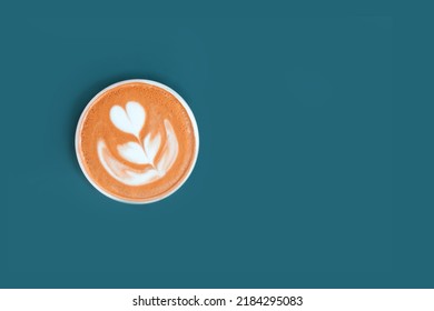 Cappuccino With Frothy Foam, Coffee Cup Top View Is On The Blue Background. Flat Lay Style. Copy Space, Cut Out.