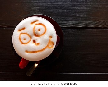 Cappuccino Latte Art With Smiley Face On Wooden Table.