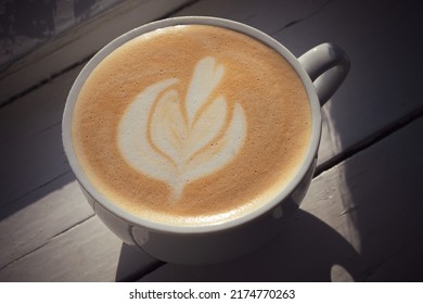 Cappuccino Next To The Window With Latte Art. Close Up