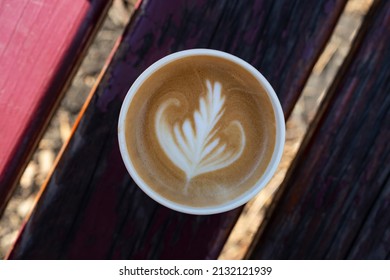 Cappuccino In A Paper Cup, On A Bench In The Park, Top View Close Up
