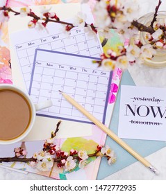 cappuccino in a white cup on a calendar and pencil background. Calendar for planning on a beautiful background. flatlay with calendar and coffee. goal setting