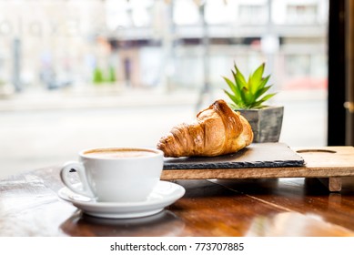 Cappuchin And Croissant In The Cafe