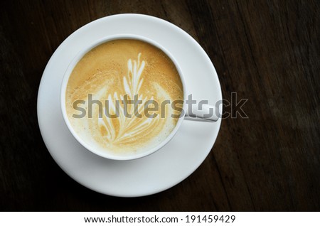 Cappucino coffee cup on wooden table