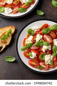 Caprese Salad With Cherry Plum Tomatoes, Mozzarella Cheese And Basil. Healthy Vegetarian Food.