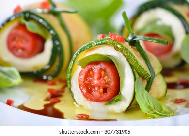 Caprese wrapped with fried zucchini slices, tied and knot with chives, marinated with olive oil and balsamic vinegar - Shutterstock ID 307731905