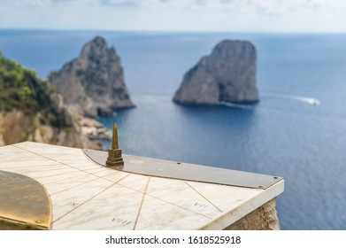 Capri Island Viewpoint With Old Coordinate Map And Blurred Faraglioni Rocks At The Background. Amalfi Coast, Italy.