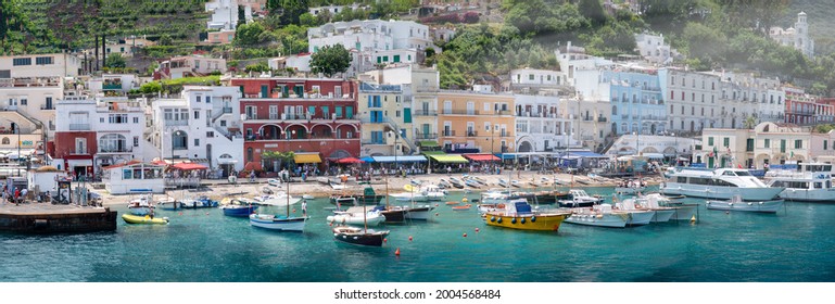 CAPRI, ITALY - JUNE 13, 2021: Small City Port With Boats And Tourists, Panoramic View