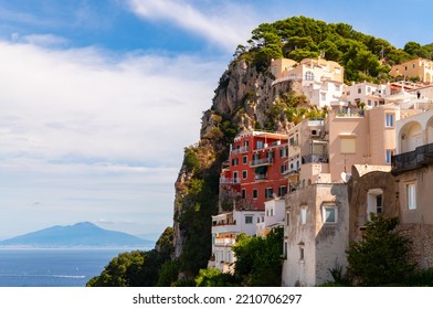 Capri Village On World Famous Capri Island Italy. Panorama Of Idyllic And Popular Tourist Destination In The Mediterranean Sea With Colorful Houses On Steep Hills. Vesuvius Volcano In The Background.