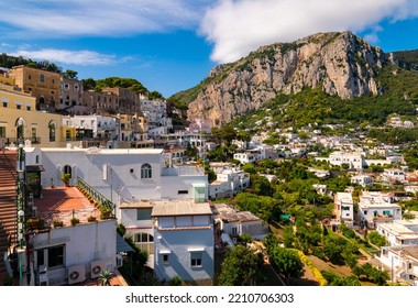 Capri Village On World Famous Capri Island Italy. Panorama Of Idyllic And Popular Tourist Destination In The Mediterranean Sea With Colorful Houses On Hills And Mountains In Picturesque Scenery.