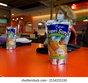 Capri-sun Fruit Drink Pouch On Burger King Restaurant Table With Defocused Woman In Background. Boston Lincs. UK. Jan 2022